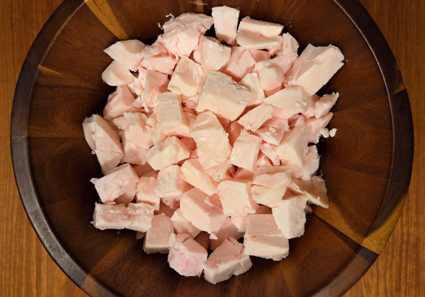 Chopped beef suet in a wooden bowl before rendering at Greene Grass Tallow.