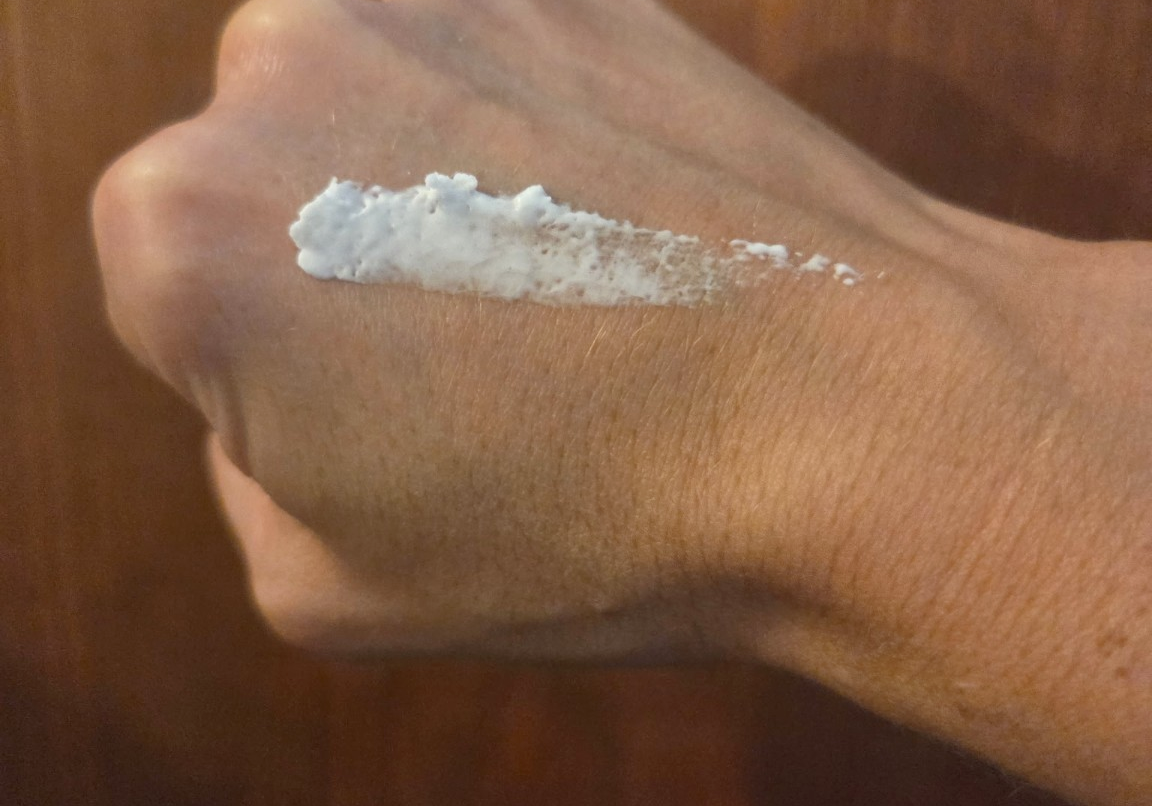 A small amount of Greene Grass Vanilla & Honey whipped tallow moisturizer on the back of a hand.
