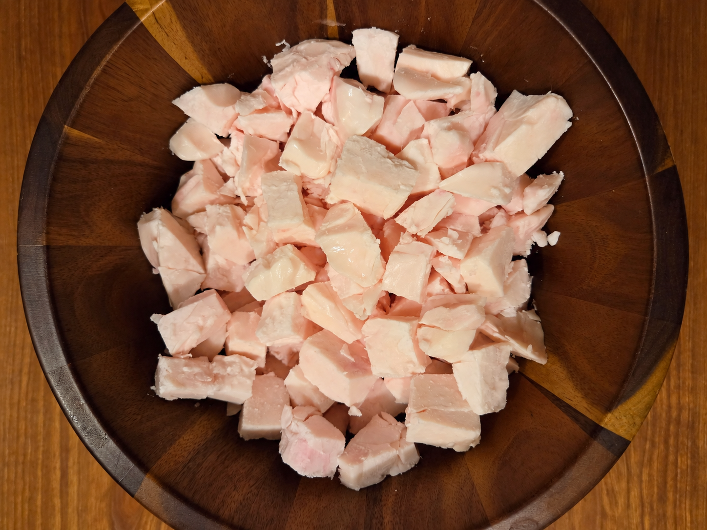 Chopped beef suet in a wooden bowl before rendering at Greene Grass Tallow.