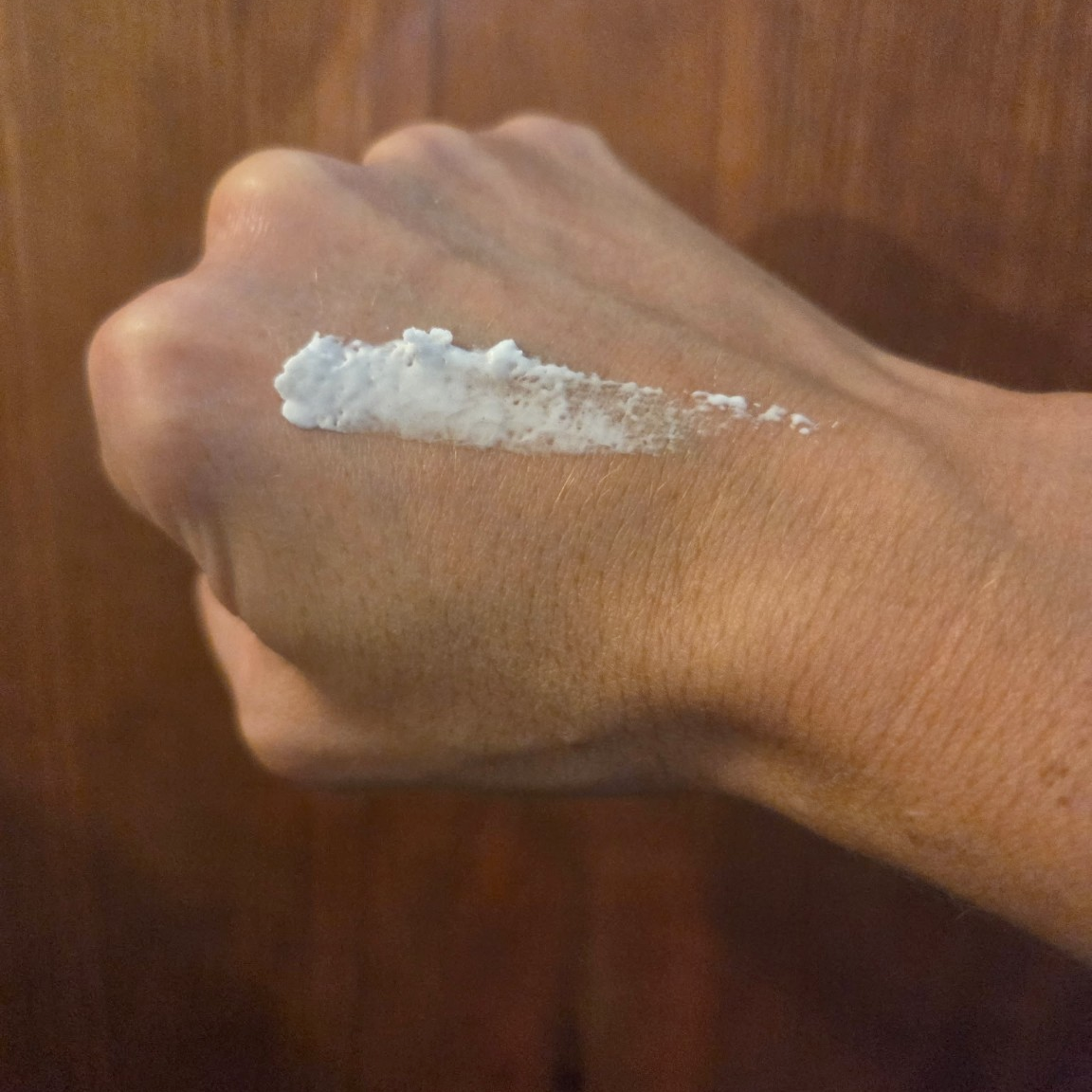 A smear of Greene Grass Vanilla & Honey whipped tallow moisturizer on the back of a hand before rubbing it in.